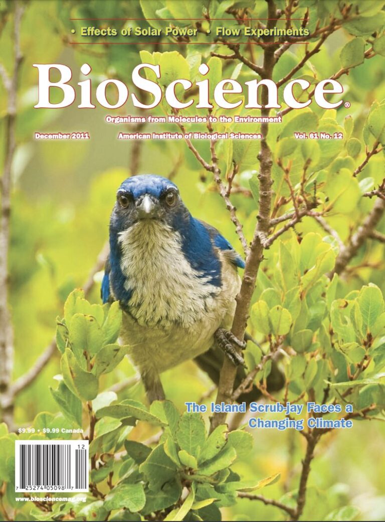 BioScience journal cover featuring the image of a blue and white bird in a leafy green tree