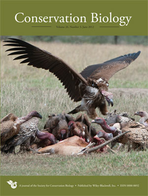 Cover of Conservation Biology journal, featuring "Issue 1" in bold text with nature-themed background: giant vultures eating a carcass