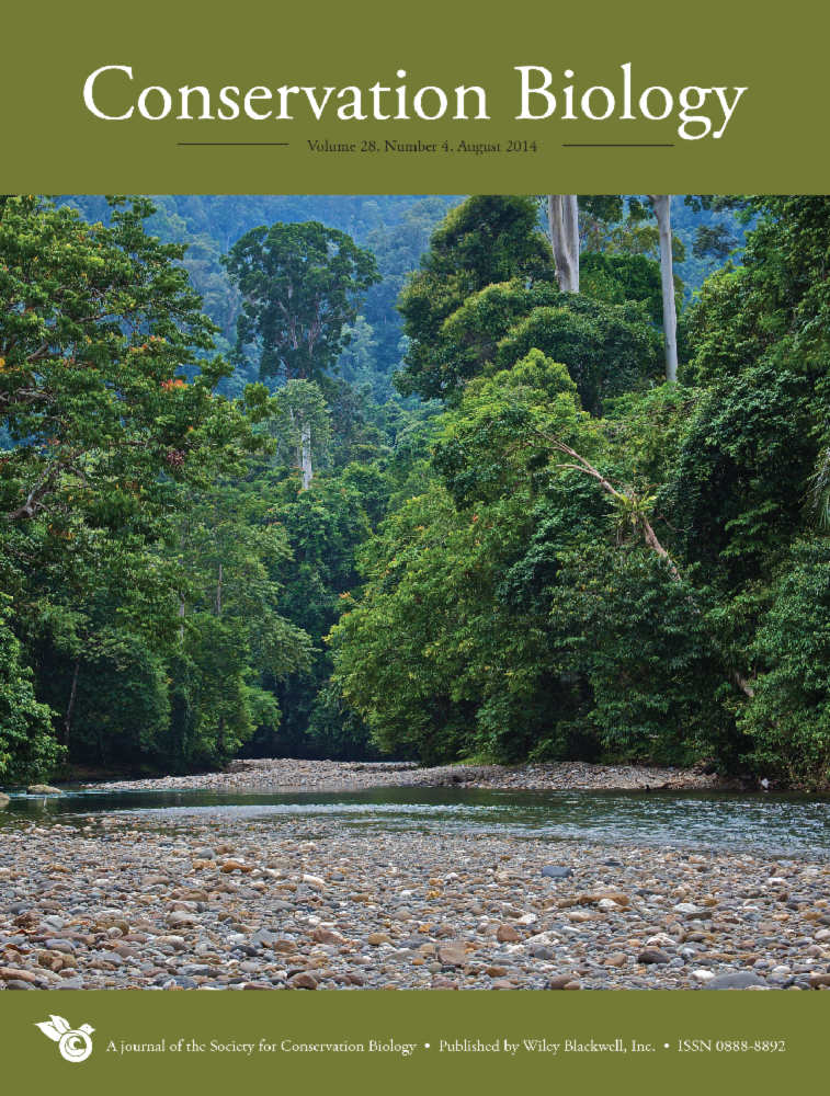 Conservation Biology journal cover featuring a wide path lined by green trees