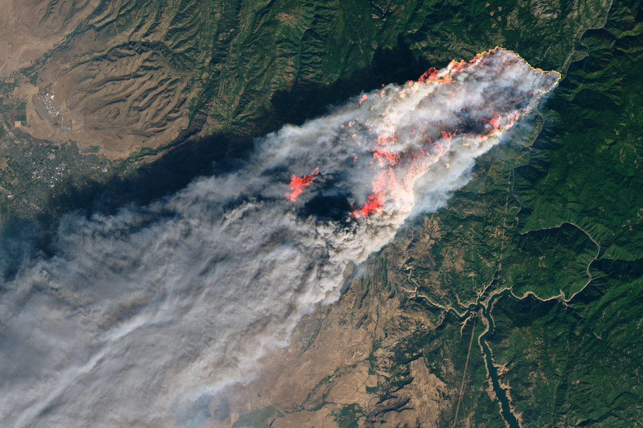 Aerial view of a wildfire burning through a large area of California