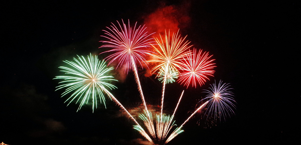 Green, pink, orange, red, and purple fireworks